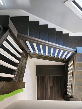 A stairway illuminated by a skylight above, creating a bright and inviting atmosphere.