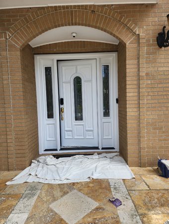 A white door with matching trim and knob, showcasing a clean and minimalist design.